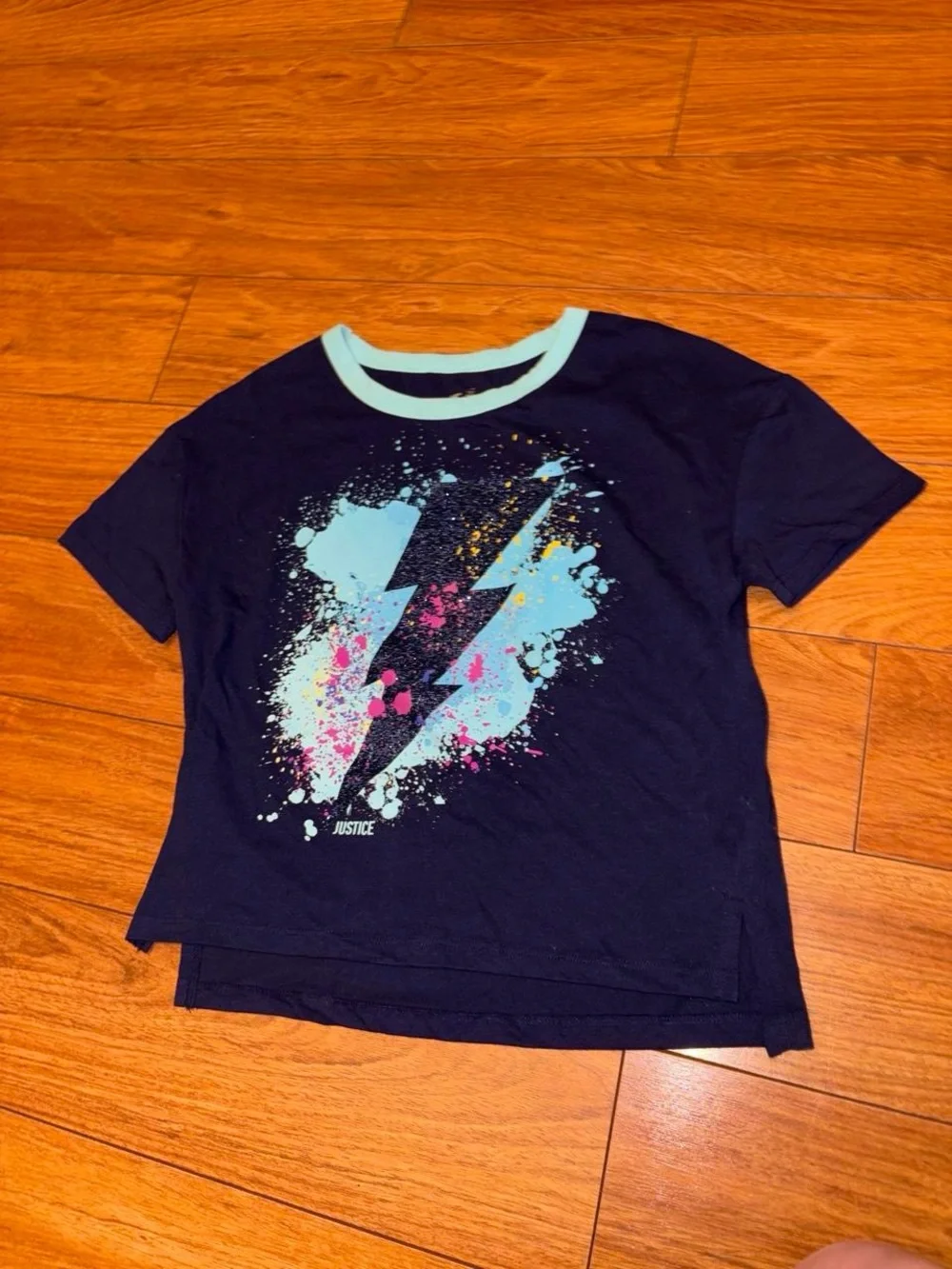 Y2K Justice navy blue tee with white lightning bolt graphic